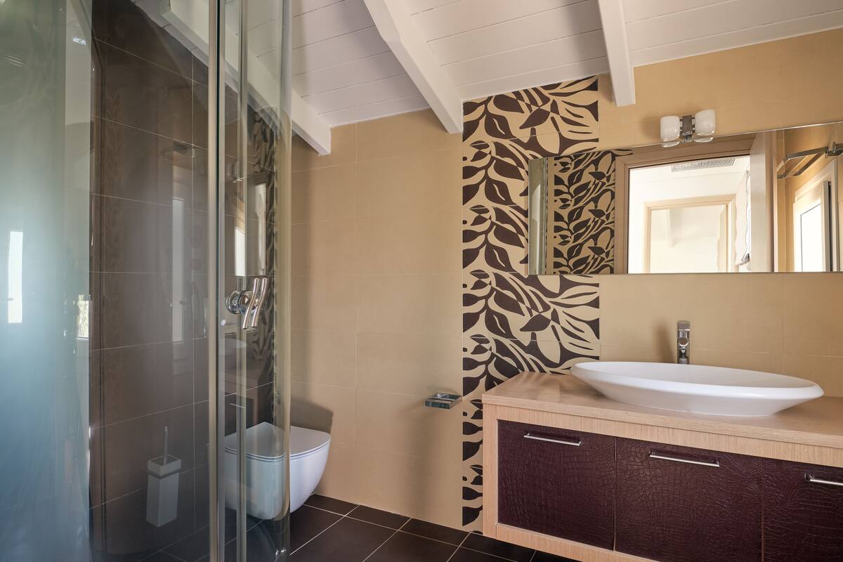 loft, pool view (suite top floor) | bathroom | shower, designer toiletries, hair dryer, slippers
