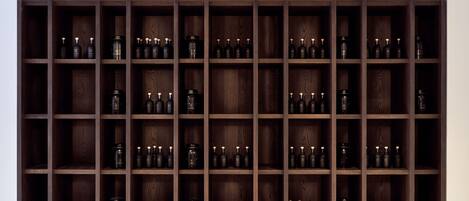 A large wooden wine rack with multiple shelves, each holding several bottles.