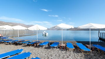 On the beach, sun-loungers, beach umbrellas