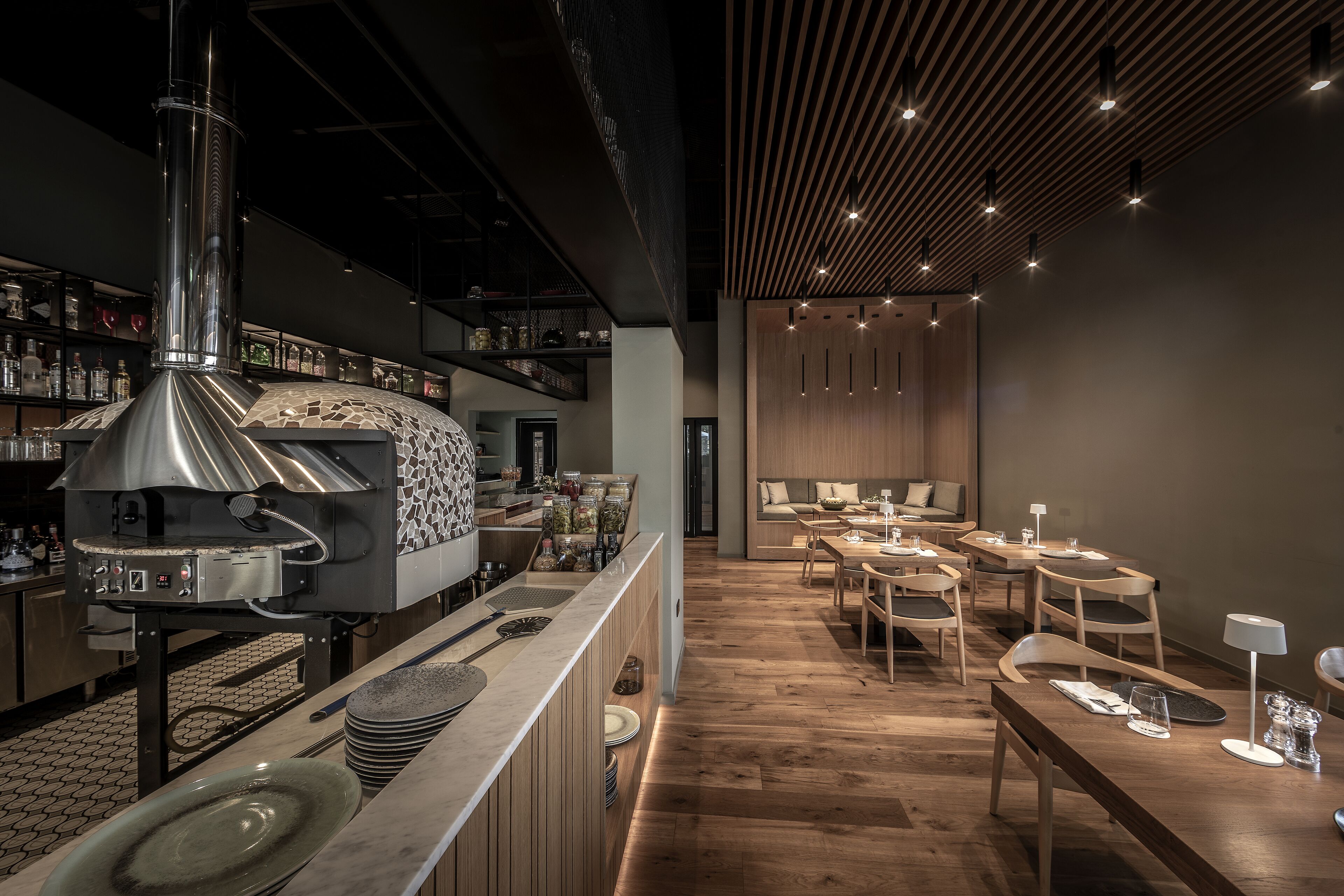 A modern kitchen with a built-in oven and a bar area.