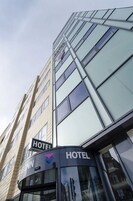 A hotel building with a sign indicating it is a hotel.