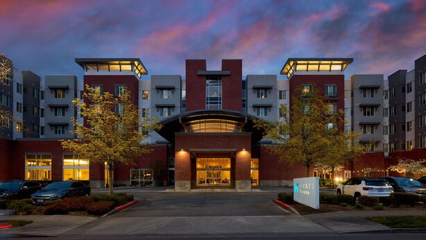 A multi-story hotel with a prominent entrance, parking area, and a sign indicating it is a Hyatt House. - Hyatt House Seattle/Bellevue (Bellevue)