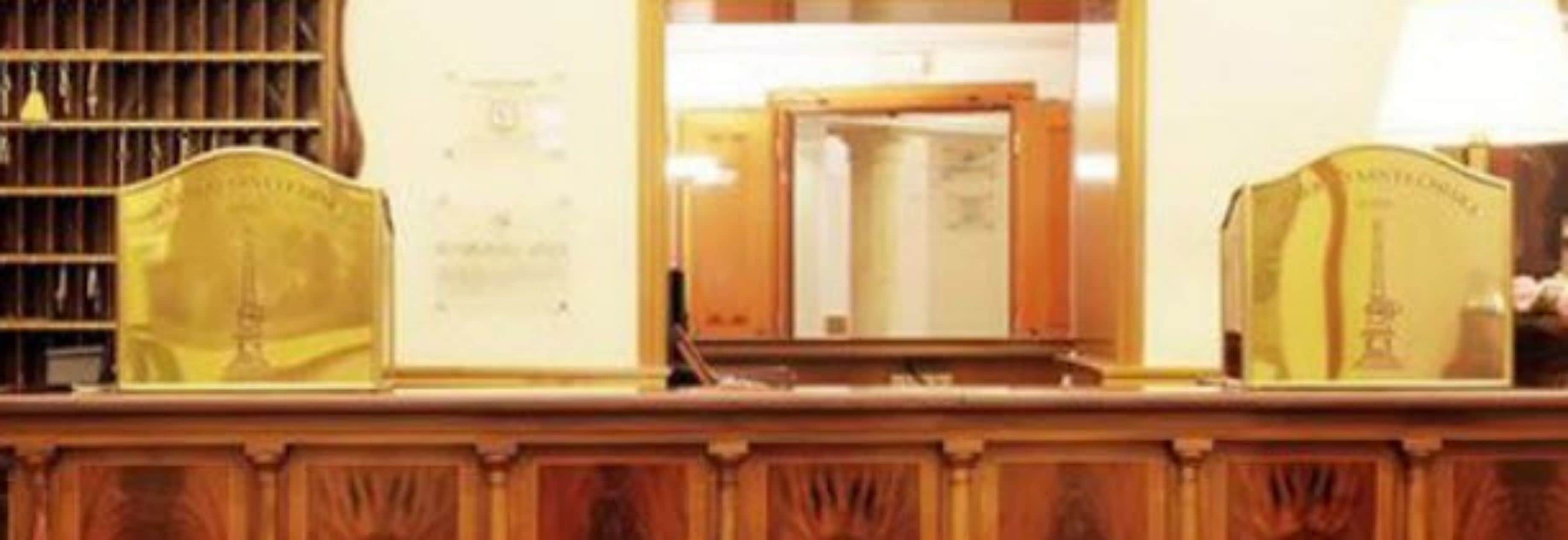 A wooden counter with a mirror and a framed certificate or award.