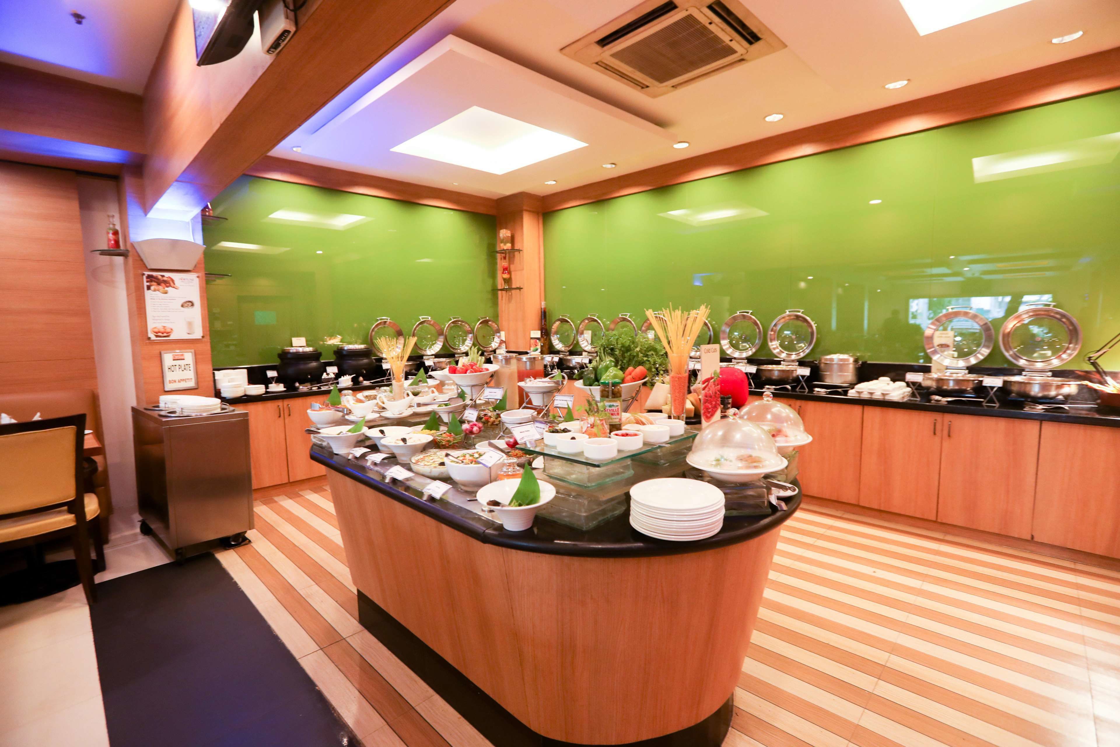 A buffet area with various food items and a counter.