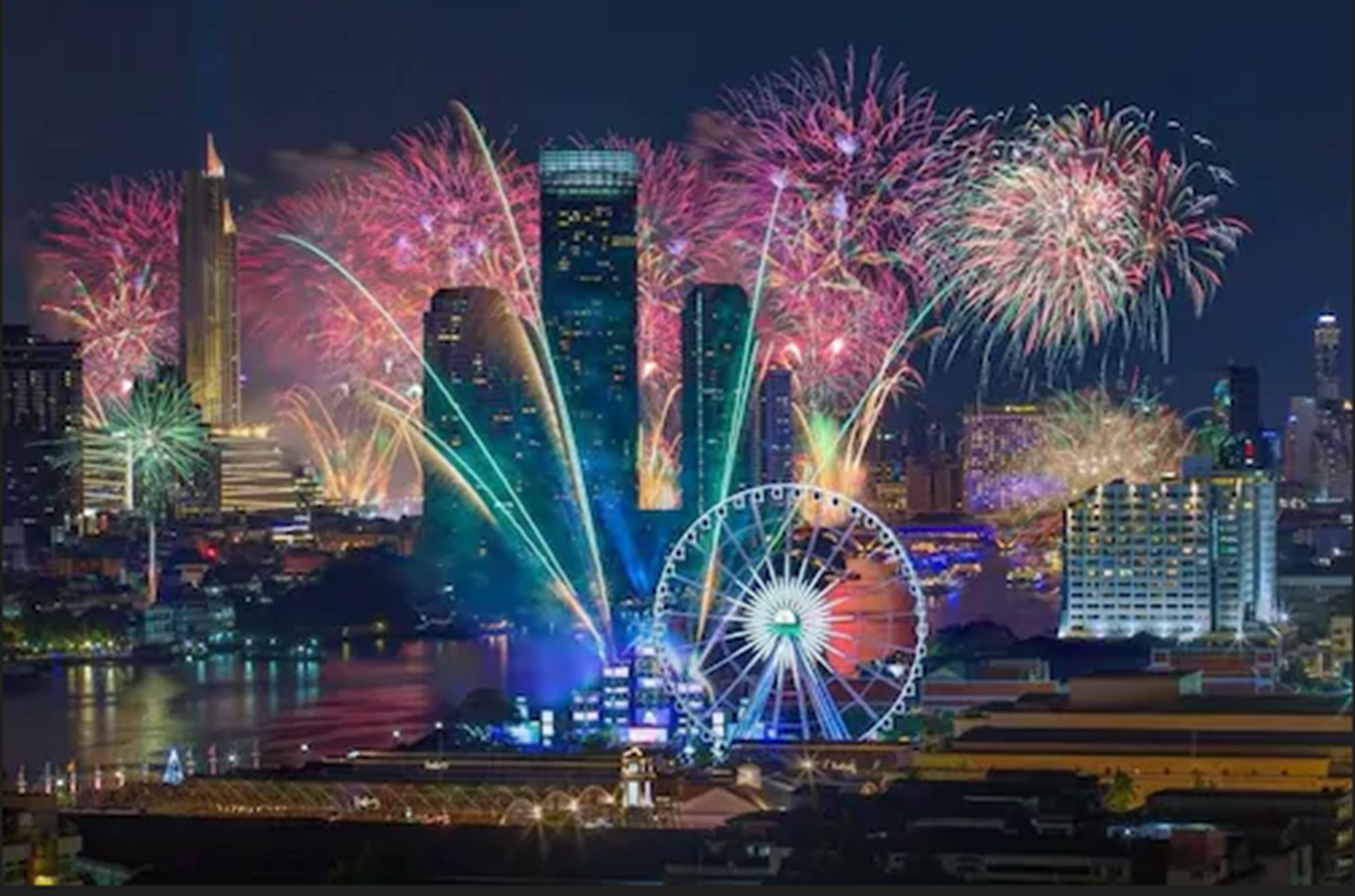 A nighttime cityscape with a prominent Ferris wheel and skyscrapers.