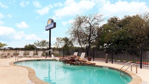 A pool area with lounge chairs, a 'No Diving' sign, and a 'Days Inn' sign. - Days Inn by Wyndham San Antonio at Palo Alto (San Antonio)