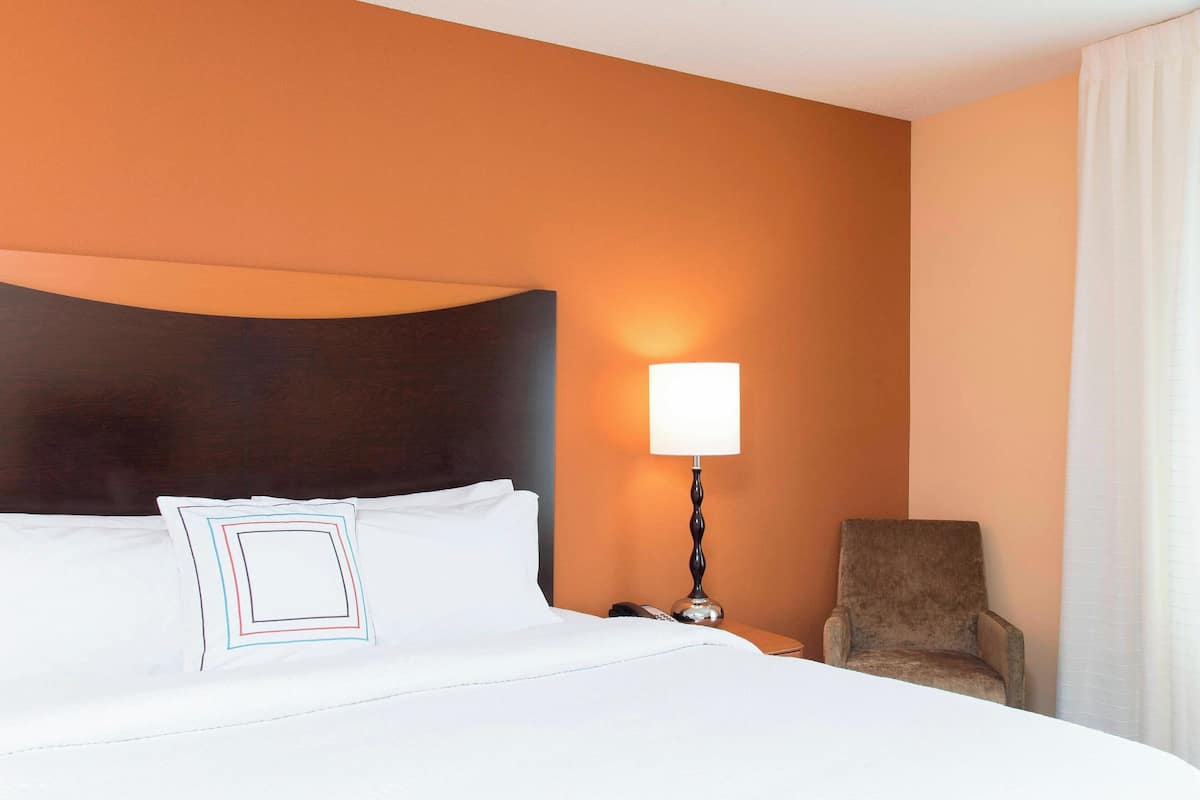 Hypo-allergenic bedding, desk, laptop workspace, blackout drapes