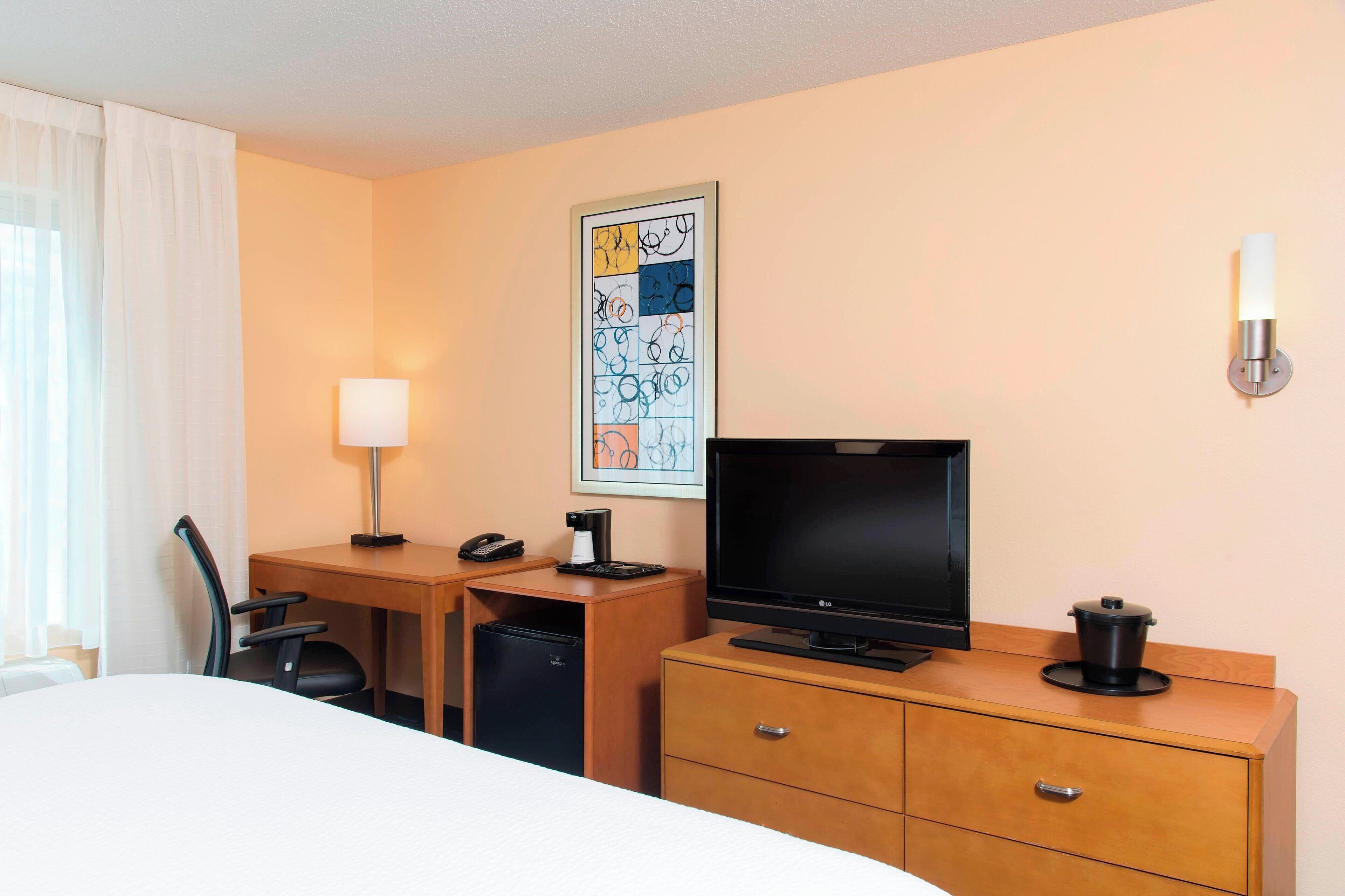 hypo-allergenic bedding, desk, laptop workspace, blackout curtains