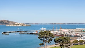 A coastal marina with boats, a pier, and a lighthouse in the background. - Fairmont Heritage Place, Ghirardelli Square (San Francisco)