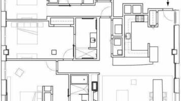 A floor plan with multiple rooms, including a kitchen, dining area, and several bedrooms.