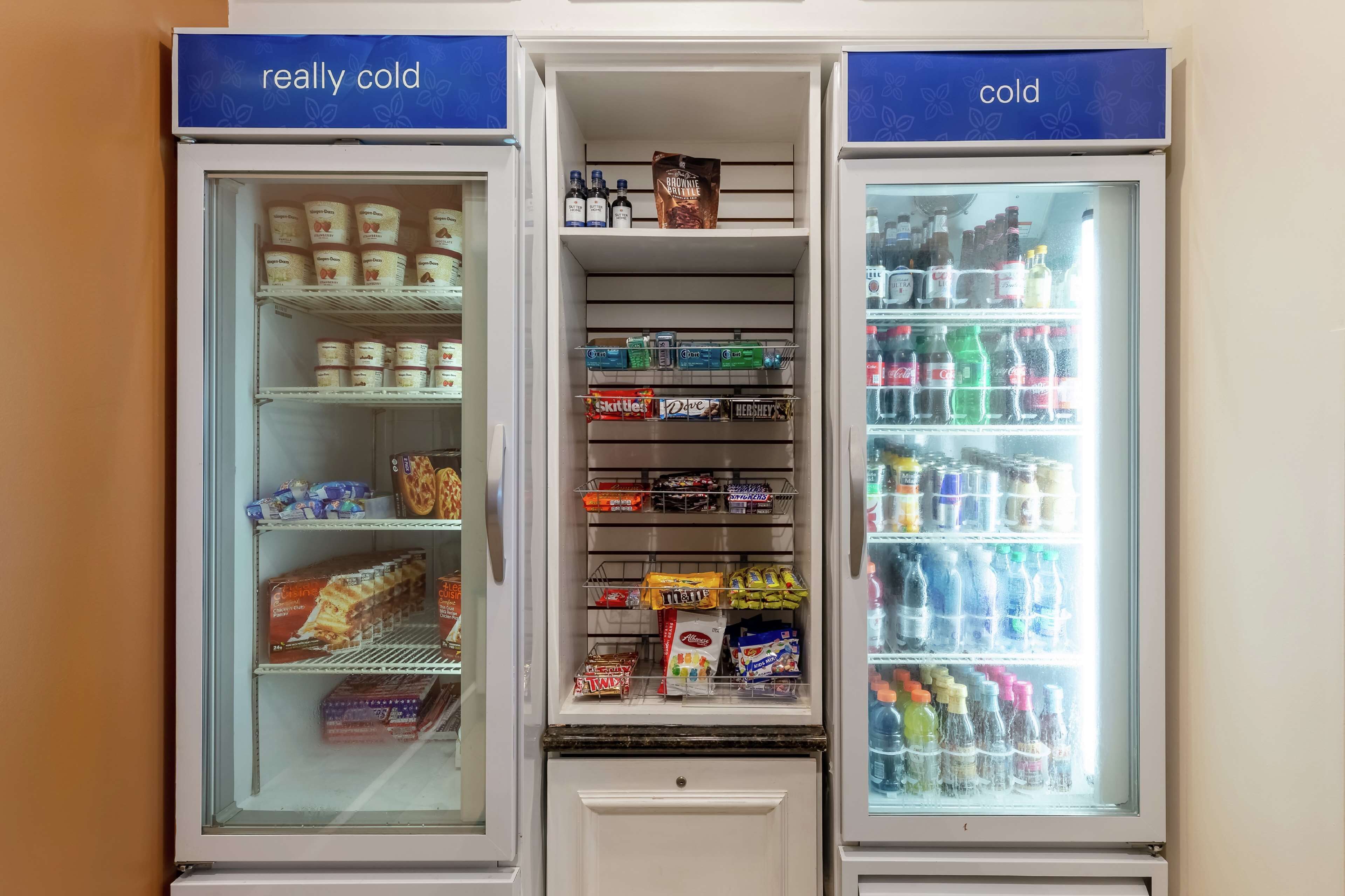 A refrigerated display case with various food items and beverages.