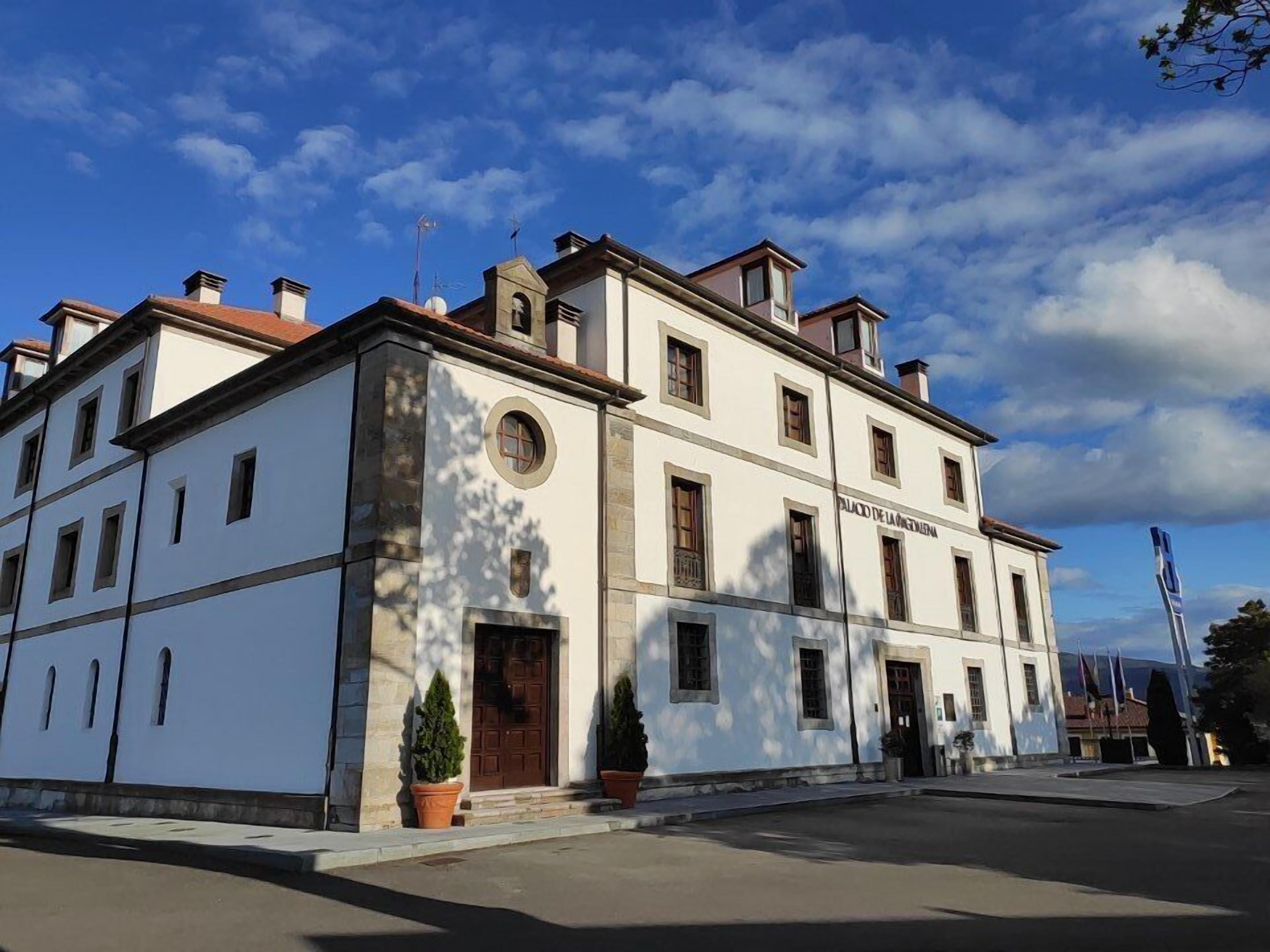 A historic building with a symmetrical facade, multiple windows, and a central entrance.