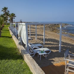 On the beach, white sand, sun-loungers, beach umbrellas