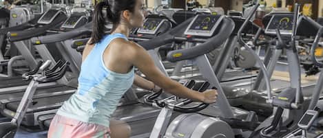 A gym with multiple treadmills and exercise equipment.