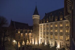 A historic building with a prominent tower and a large hotel facade. - Dukes’ Palace – by Dukes’ Hotel Collection (Bruges)