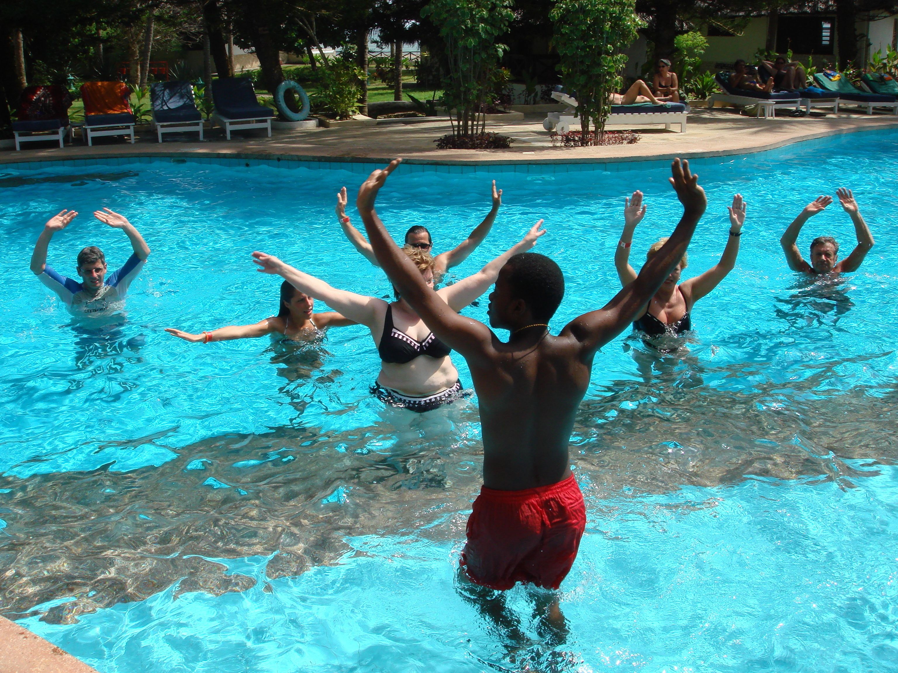 A swimming pool with people exercising in the water.
