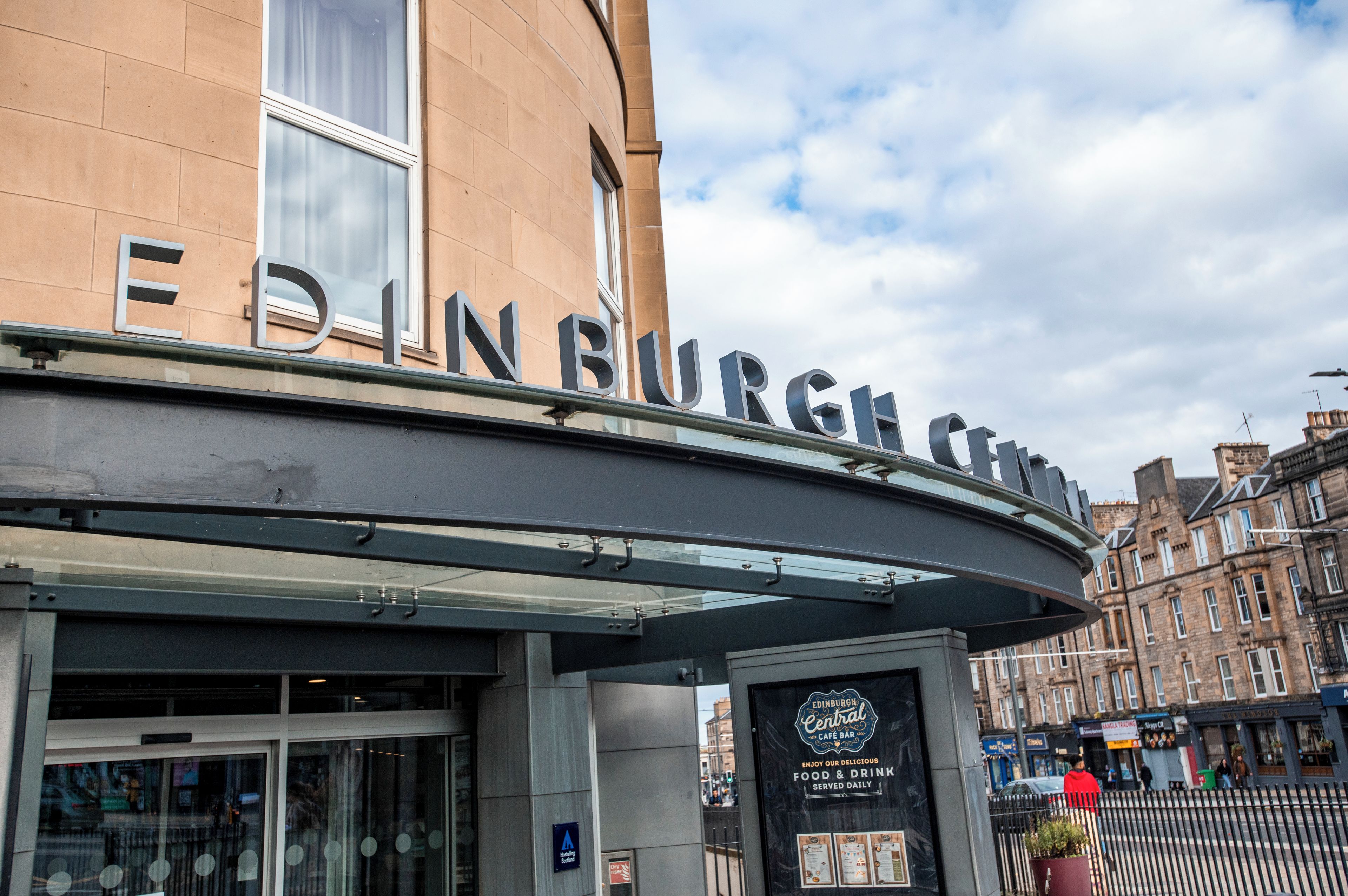The Edinburgh Central building with a clear sign, a glass entrance, and a metal awning.