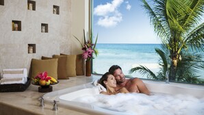 A couple relaxing in a bathtub with a view of the ocean. - El Dorado Maroma, All & More Inclusive - Adults Only (Playa del Carmen)
