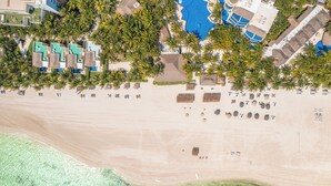 An aerial view of a resort with multiple bungalow-style accommodations, a central pool area, and a beachfront. - El Dorado Maroma, All & More Inclusive - Adults Only (Playa del Carmen)
