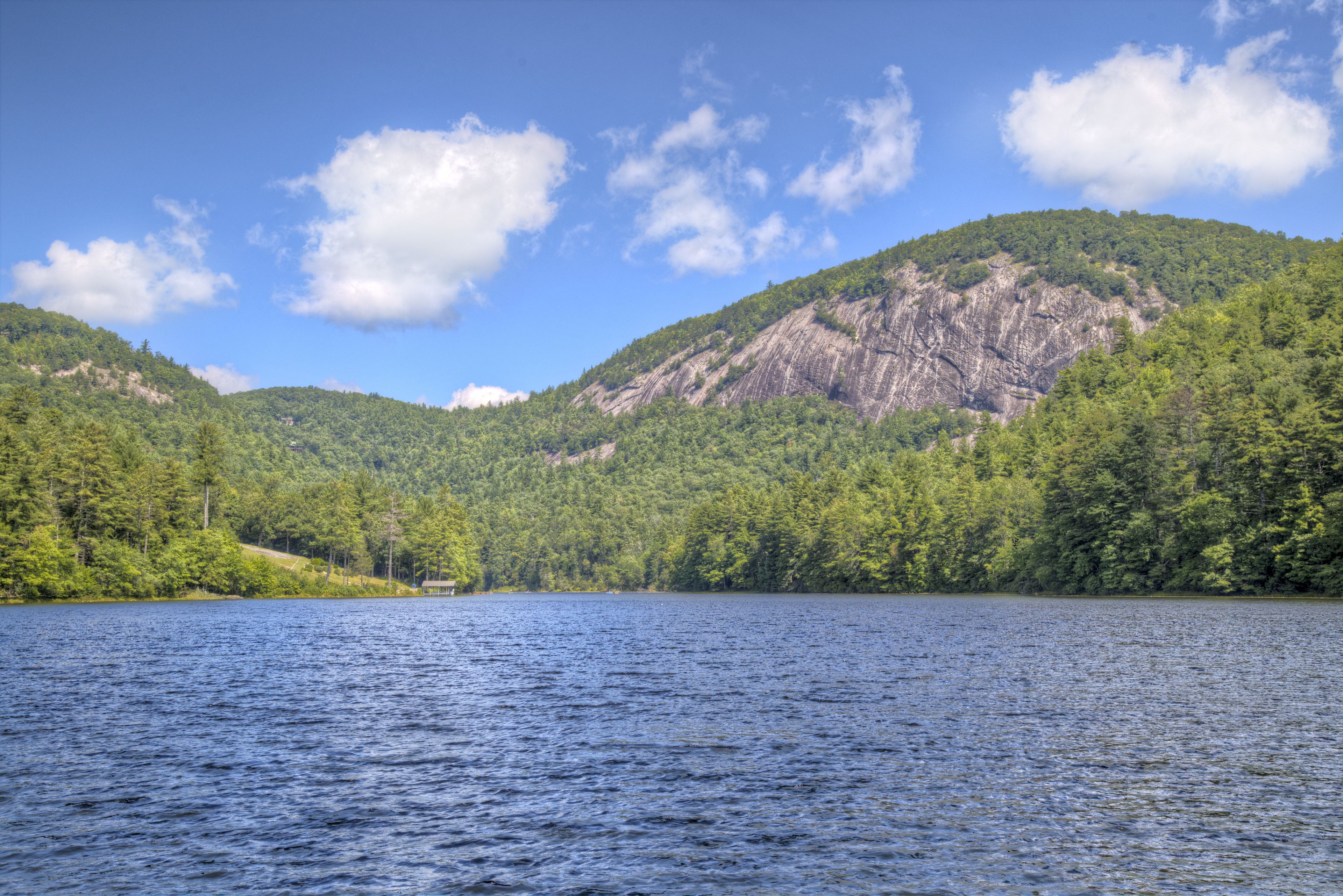 A lake surrounded by forested hills.