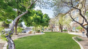 A well-maintained lawn with mature trees and a stone building in the background. - La Quinta Inn & Suites by Wyndham St. George (St. George)