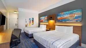 A hotel room with two beds, a desk, a chair, and artwork on the walls. - La Quinta Inn & Suites by Wyndham St. George (St. George)
