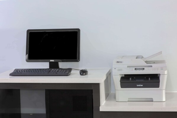 A desk with a Dell monitor, a Brother printer, and a keyboard. - La Quinta Inn & Suites by Wyndham Mobile - Daphne (Daphne)