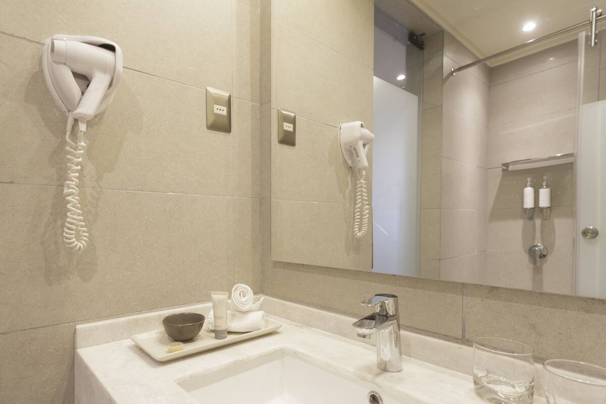 rainfall showerhead, eco-friendly toiletries, hair dryer, towels