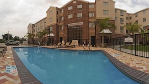 A hotel with a swimming pool, lounge chairs, and a 'No Diving' sign. - Staybridge Suites McAllen by IHG (McAllen)