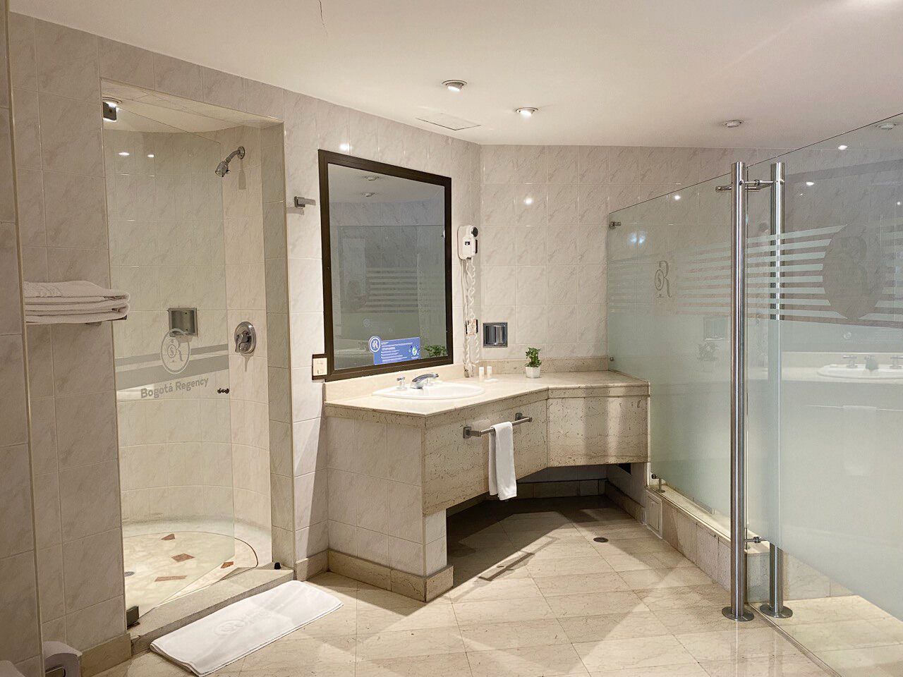 deluxe studio suite | bathroom | rainfall showerhead, hair dryer, towels, soap