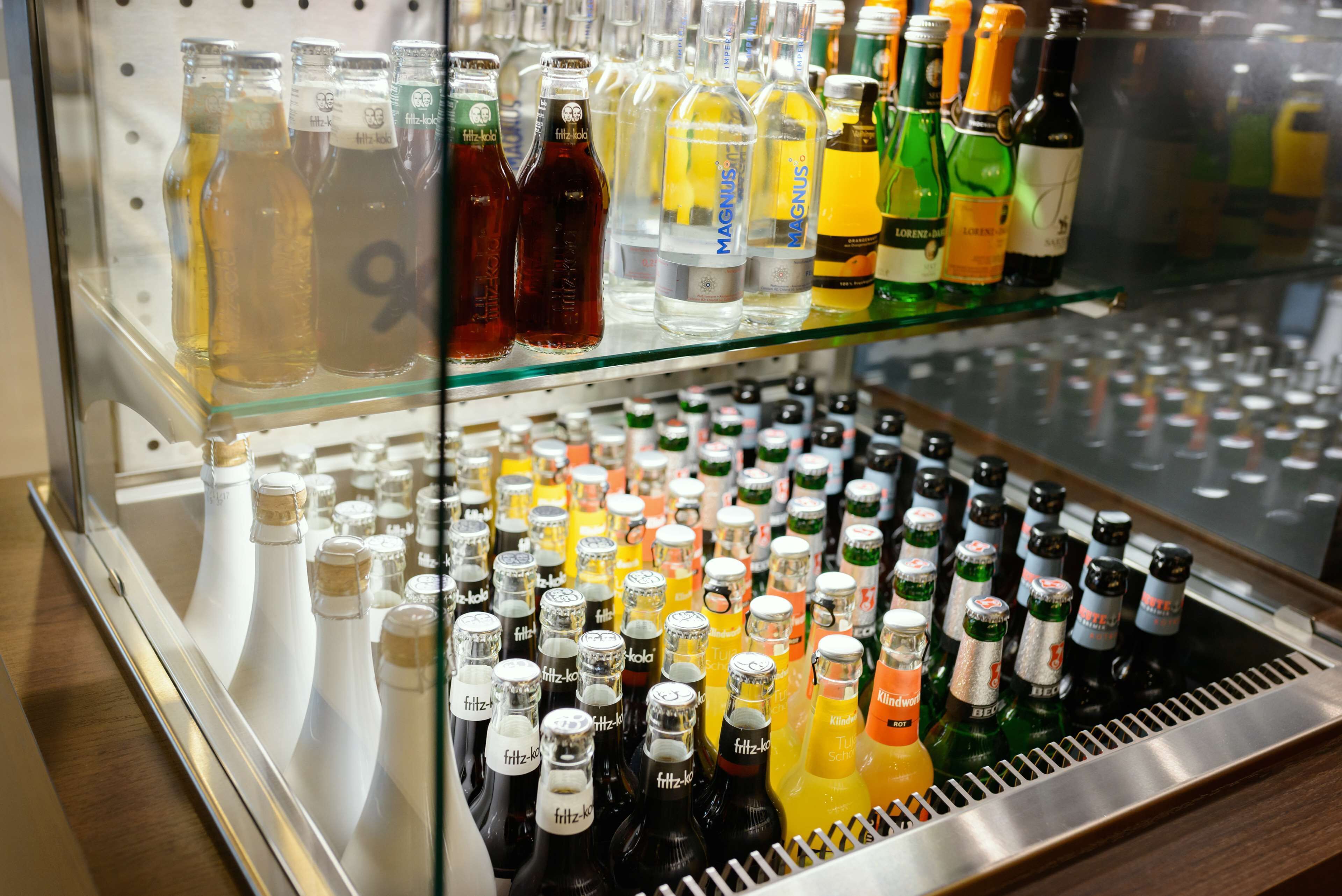 A refrigerated display case with various bottled beverages.