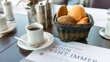 A breakfast setting with a basket of bread, a cup of coffee, and a menu.