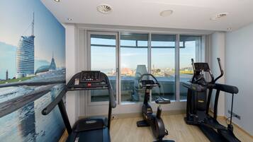 A gym with treadmills, an elliptical, and a stationary bike.