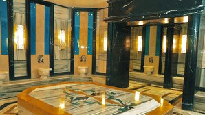 A luxurious bathroom with marble floors, a central bathtub, and multiple sinks. - The Green Park Kartepe (Kartepe)