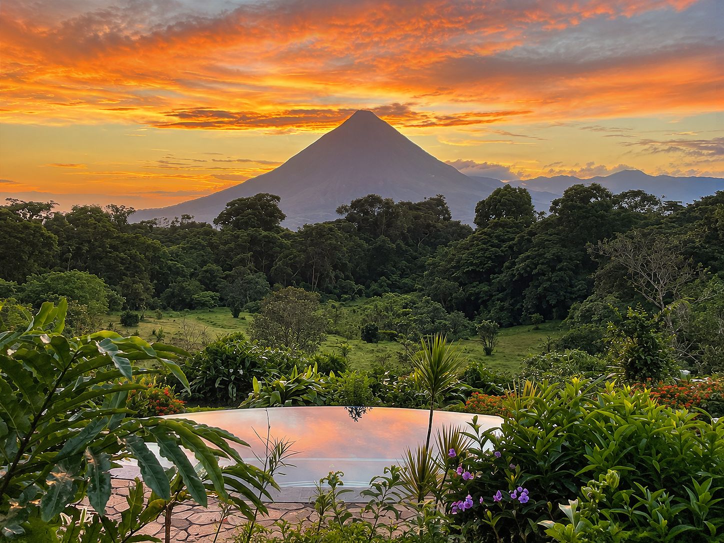 A lush landscape with a prominent mountain in the background and a reflective pool in the foreground.