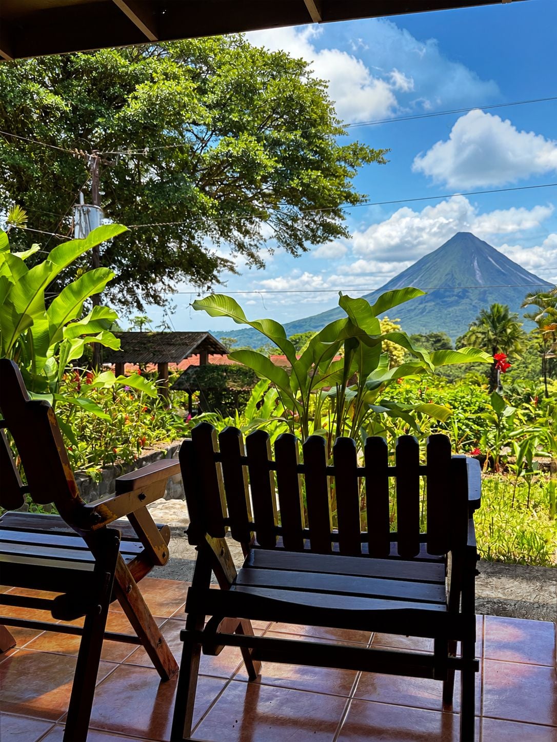 A wooden bench with a view of a mountain.