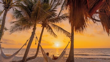 On the beach, white sand, free beach cabanas, sun-loungers