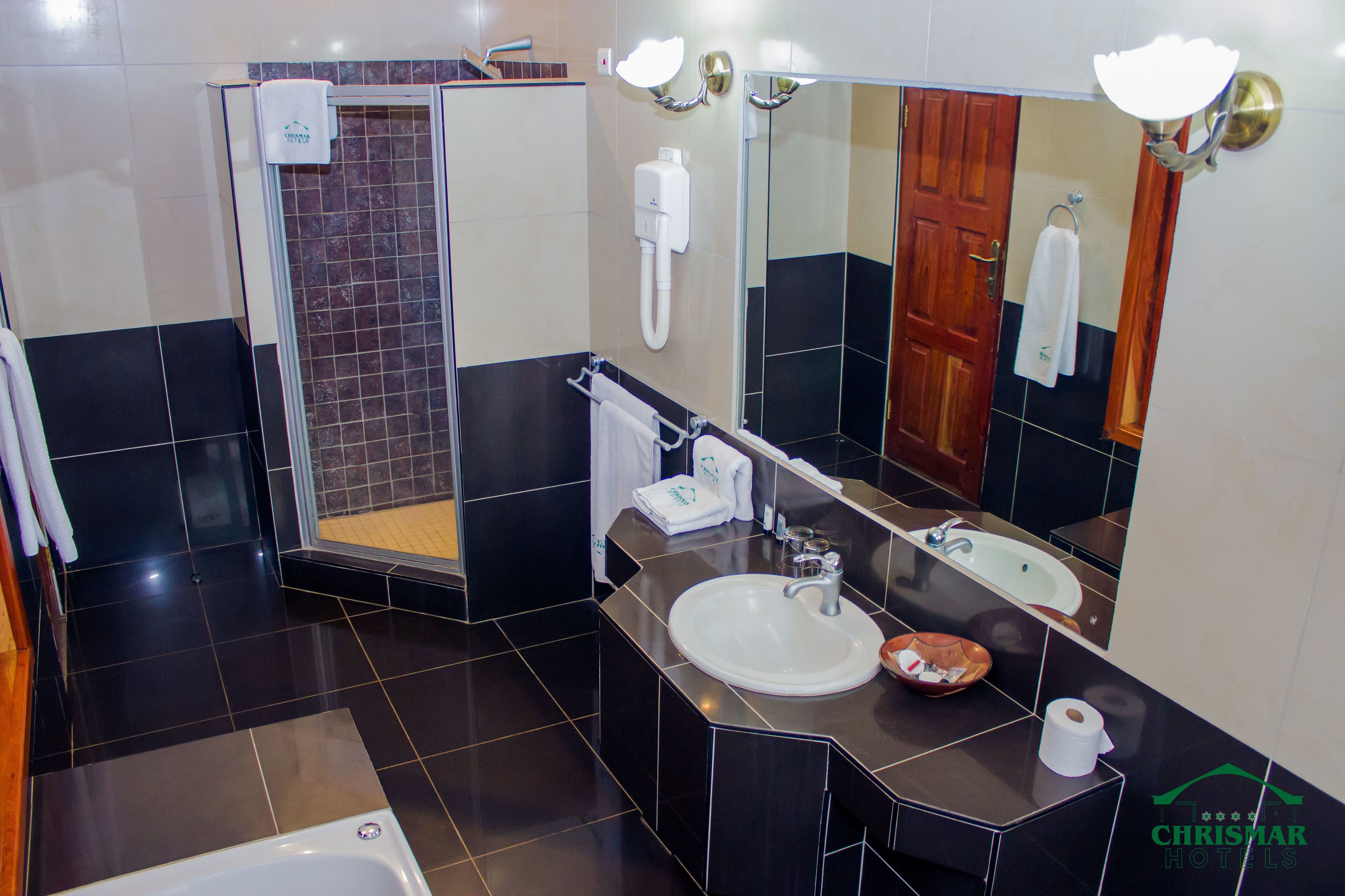 A modern bathroom with a bathtub, a sink, a shower, and a toilet.