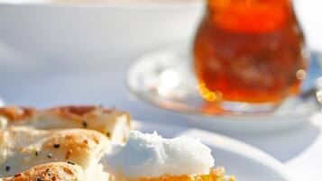A plate with food and a cup of tea.