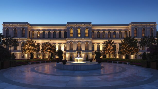 A large, classical building with a central fountain, surrounded by a circular courtyard with benches and trees. - Four Seasons Hotel Istanbul at the Bosphorus (Istanbul)