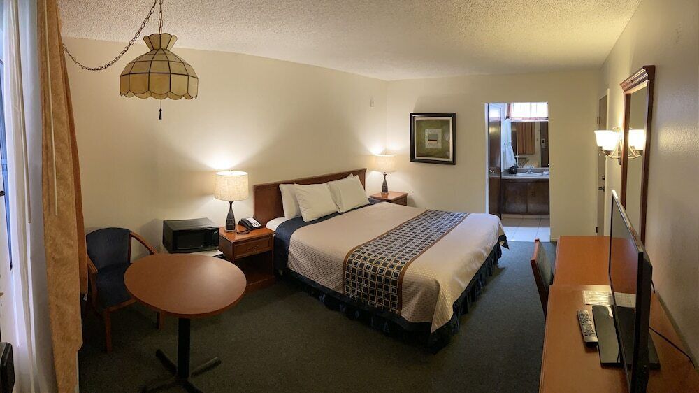 Hypo-allergenic bedding, desk, laptop workspace, blackout drapes
