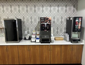 A coffee station with a Nescafé machine, a refrigerator, and a juice dispenser. - Red Roof Inn Port Charlotte - Punta Gorda (Port Charlotte)