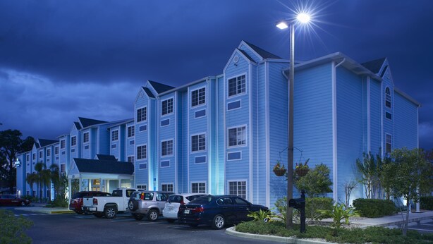 A multi-story hotel with a parking lot. - Microtel Inn & Suites by Wyndham Port Charlotte/Punta Gorda (Port Charlotte)