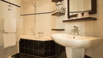 A modern bathroom with a bathtub, a sink, and a shower.