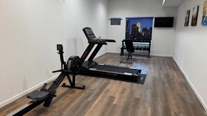 A home gym with a treadmill, elliptical, and dumbbells. - Comfort Inn San Antonio Northeast (San Antonio)