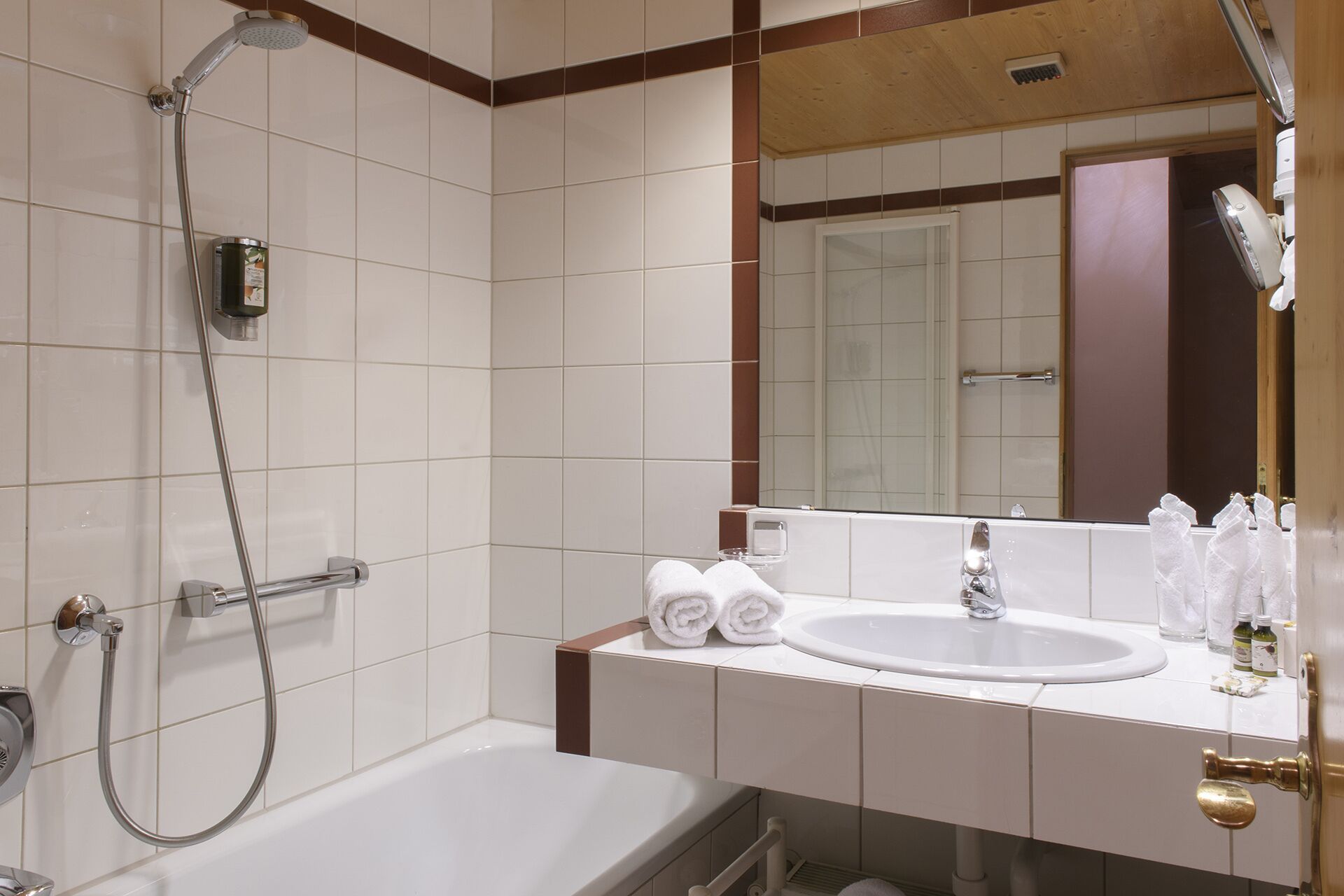 A bathroom with a bathtub, a sink, and a shower.