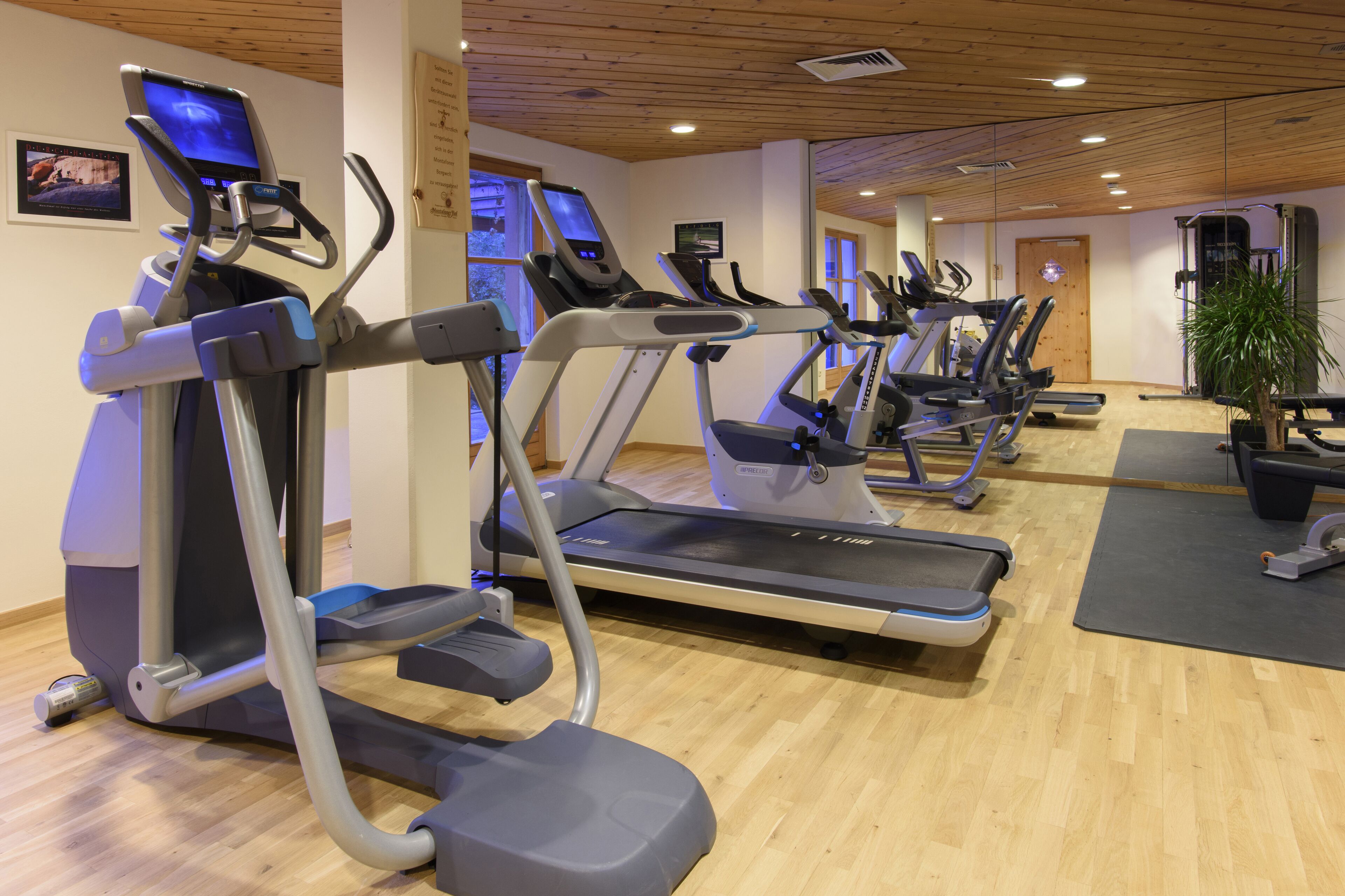 A gym with treadmills, stationary bikes, and a weight machine.