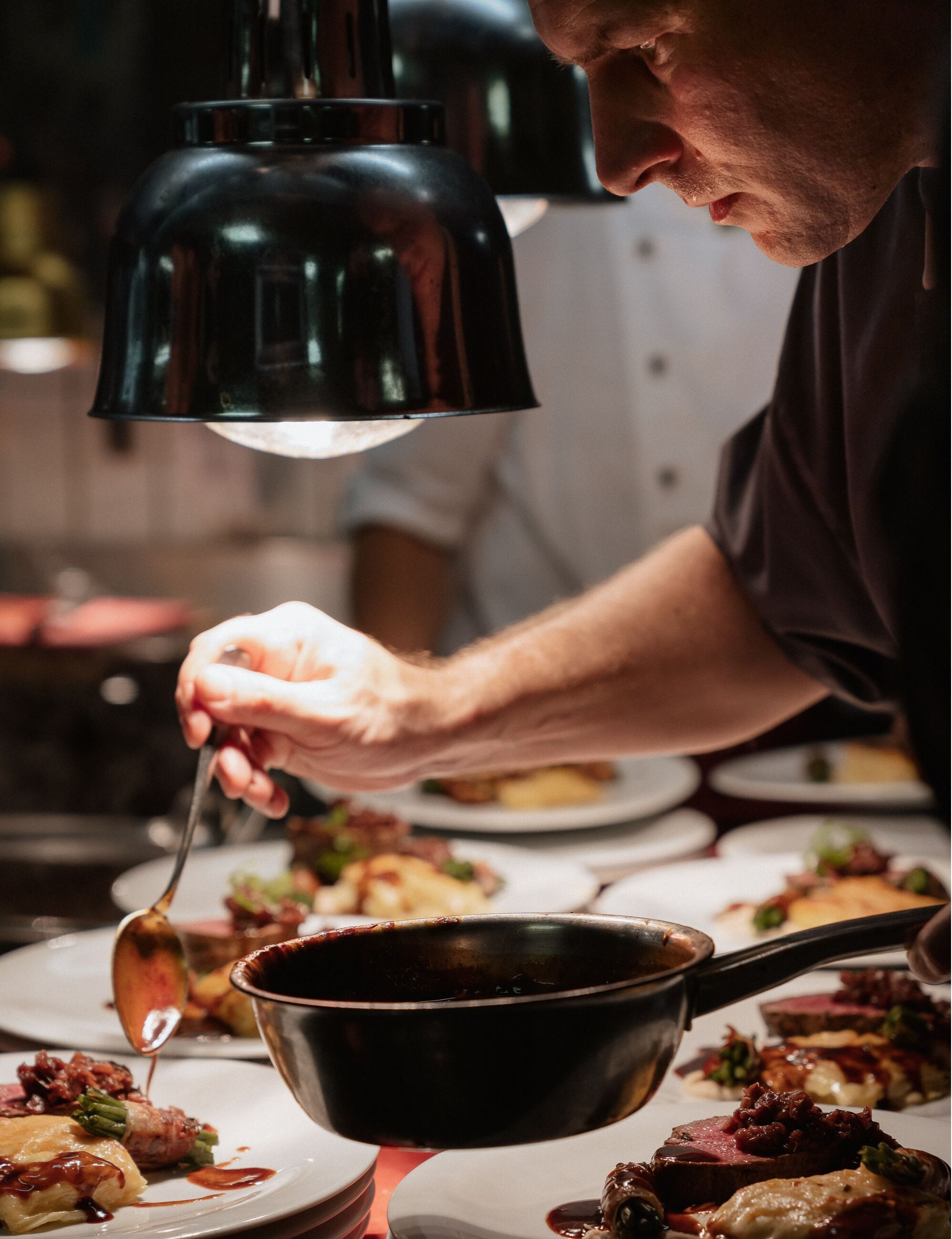 A person serving food from a pot.