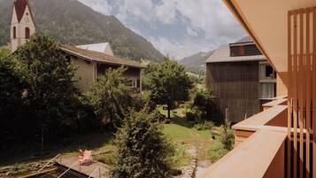 A residential area with a church, houses, and a mountain backdrop.