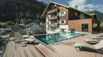 Indoor pool, outdoor pool, pool umbrellas, pool loungers